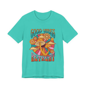 Women turquoise short-sleeve crewneck t-shirt featuring a colorful retro 70s-style graphic with mushrooms, flowers, and the words 'GOOD VIBES RETREAT' | AH Urban Wear PK